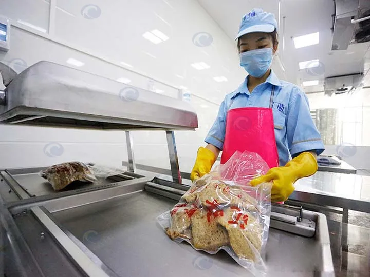 Meat vacuum packing machine in operation